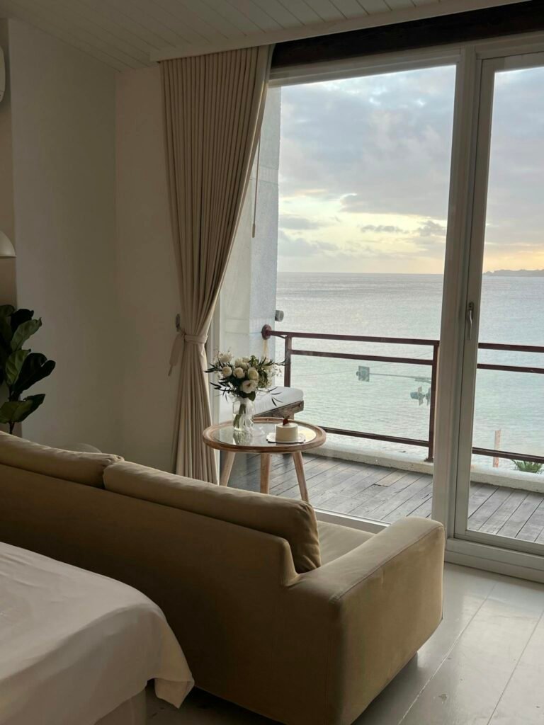 Elegant living room with ocean view balcony, perfect for relaxation and inspiration.